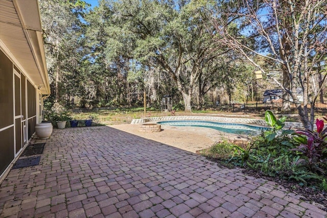 view of pool with a patio and an outdoor fire pit