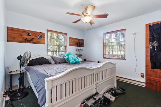 bedroom featuring baseboard heating, multiple windows, and ceiling fan