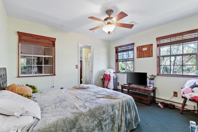 carpeted bedroom featuring ceiling fan and a baseboard heating unit