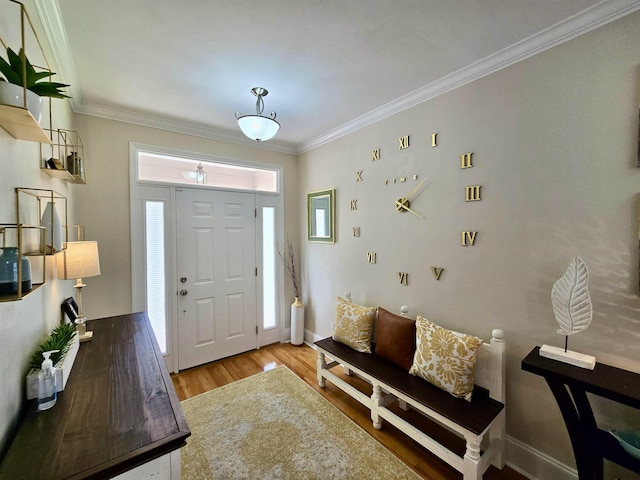 entryway featuring a wealth of natural light, ornamental molding, and wood finished floors