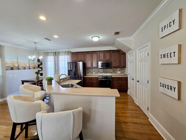 kitchen featuring appliances with stainless steel finishes, crown molding, a chandelier, and visible vents