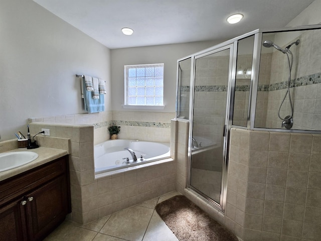 full bathroom featuring a shower stall, vanity, tile patterned flooring, and a bath