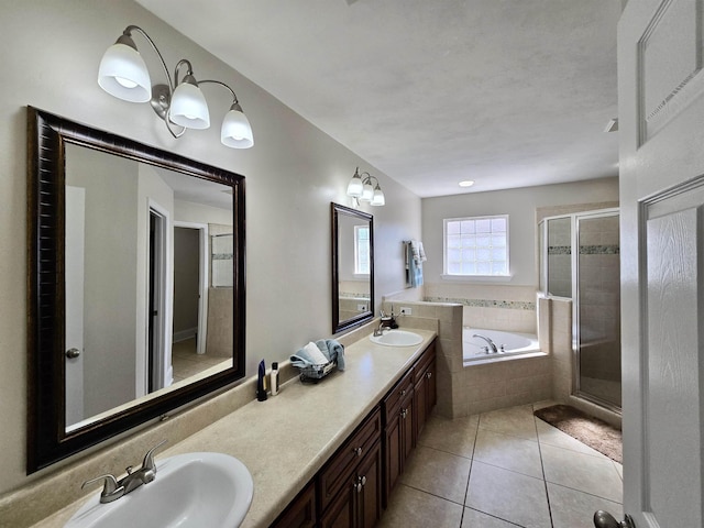 full bathroom featuring tile patterned floors, a sink, a shower stall, and a bath