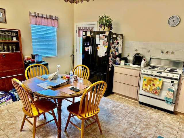 dining area featuring light tile patterned flooring