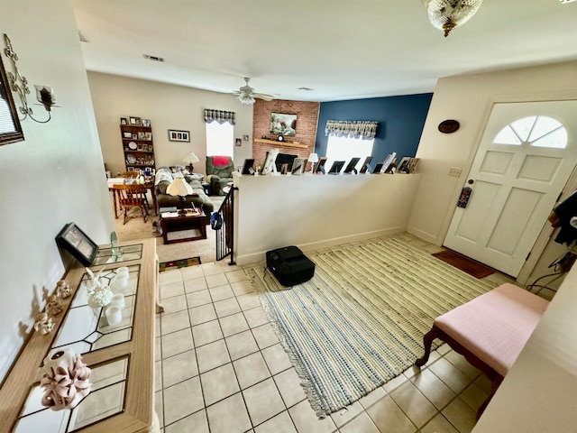 tiled foyer with ceiling fan