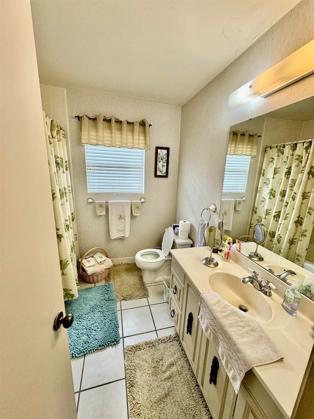 bathroom featuring tile patterned floors, vanity, and toilet