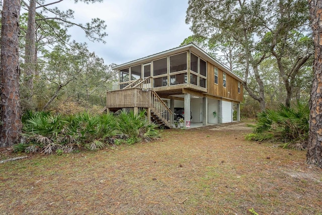 rear view of property with a sunroom