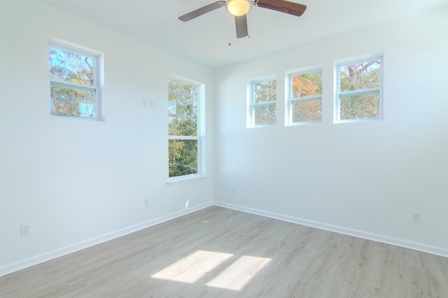 unfurnished room featuring ceiling fan, a healthy amount of sunlight, and light hardwood / wood-style floors