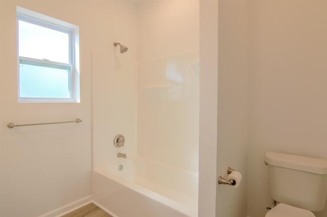 bathroom with tub / shower combination and toilet