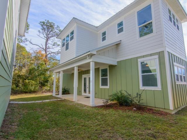 back of property featuring a yard and a patio