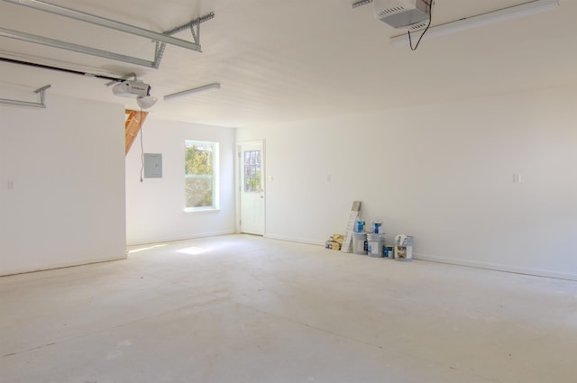 garage with a garage door opener and electric panel