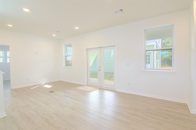 spare room with light wood-type flooring and french doors