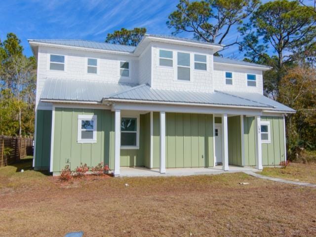 rear view of house featuring a porch