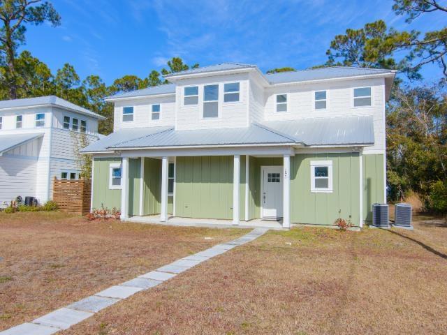 view of front of home featuring central AC and a front yard