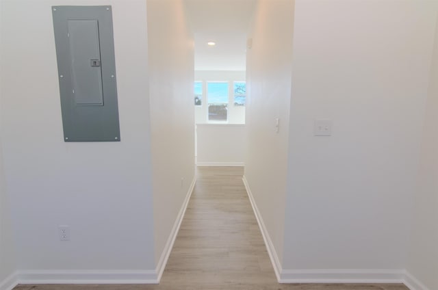 corridor featuring electric panel and light hardwood / wood-style flooring