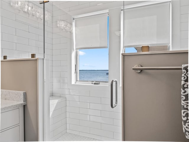 bathroom with a water view, an enclosed shower, and vanity