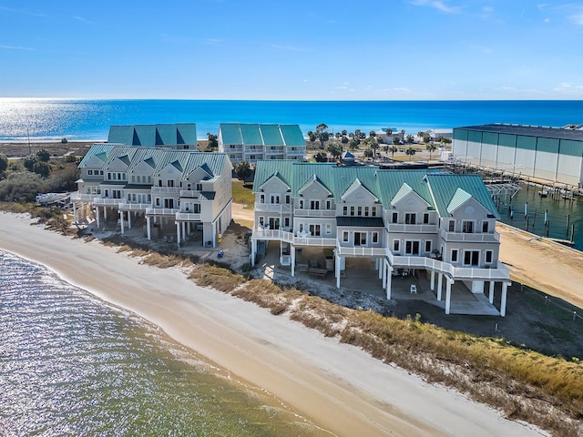 birds eye view of property with a view of the beach and a water view