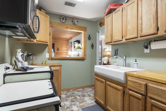 kitchen with sink and a textured ceiling