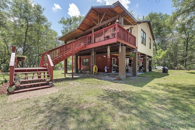 rear view of property featuring a wooden deck and a yard