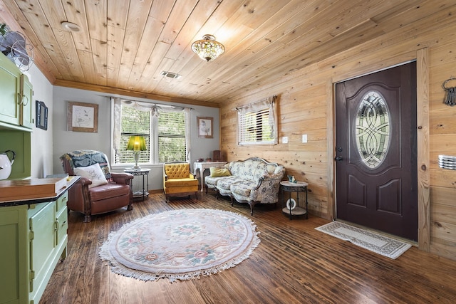 living area with dark hardwood / wood-style flooring, wood ceiling, wooden walls, and crown molding