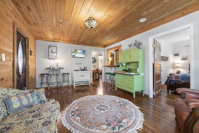 living room featuring dark hardwood / wood-style flooring, ornamental molding, and wooden ceiling