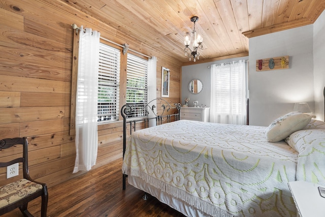 bedroom with dark hardwood / wood-style flooring, a notable chandelier, multiple windows, and wooden ceiling