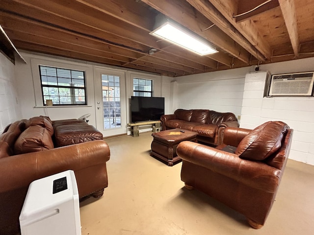 living room with a wall mounted air conditioner and concrete floors