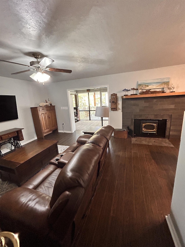 living room with hardwood / wood-style flooring, ceiling fan, and a textured ceiling