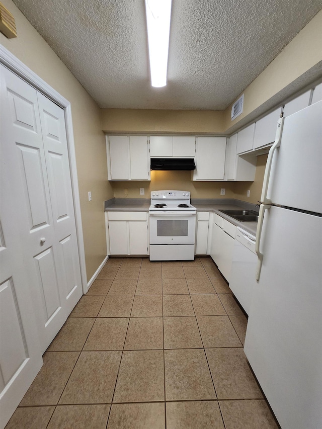 1100 Green Tree Ct Unit C, Tallahassee, FL 32304 - kitchen with white appliances, under cabinet range hood, a textured ceiling, light tile patterned floors, and white cabinets