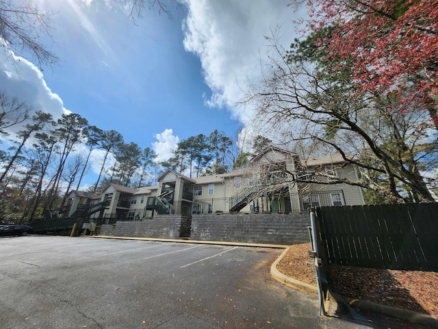 1100 Green Tree Ct Unit C, Tallahassee, FL 32304 - view of front facade with fence, uncovered parking, and a residential view