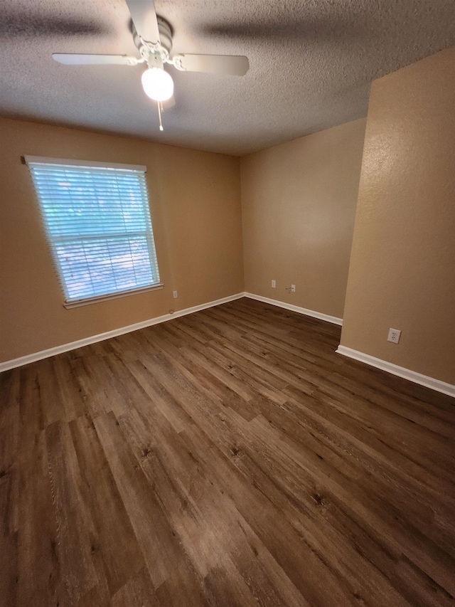1100 Green Tree Ct Unit C, Tallahassee, FL 32304 - unfurnished room featuring a textured ceiling, dark wood-style floors, baseboards, and ceiling fan