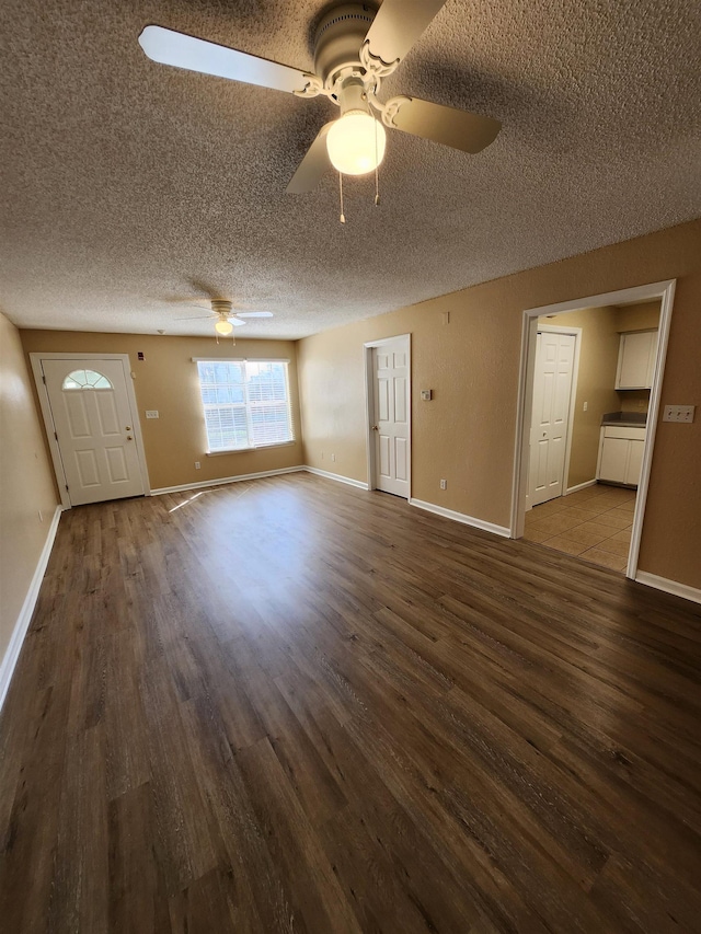 1100 Green Tree Ct Unit C, Tallahassee, FL 32304 - unfurnished living room featuring wood finished floors, a textured ceiling, ceiling fan, and baseboards