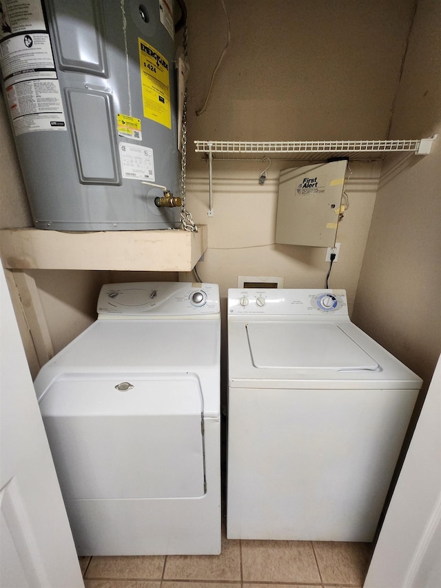 1100 Green Tree Ct Unit C, Tallahassee, FL 32304 - clothes washing area with water heater, washer and dryer, and light tile patterned flooring