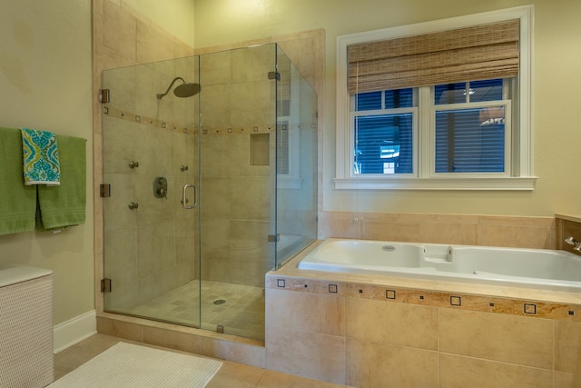 bathroom featuring tile patterned flooring and separate shower and tub