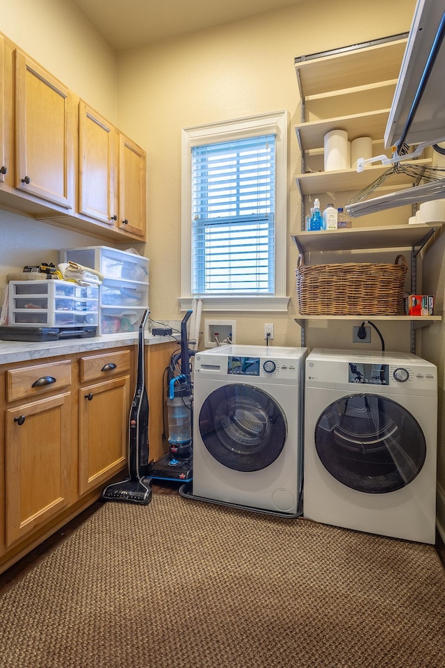 laundry area featuring washing machine and dryer and cabinets