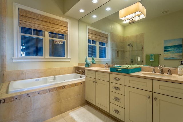 bathroom with tile patterned flooring, vanity, and shower with separate bathtub