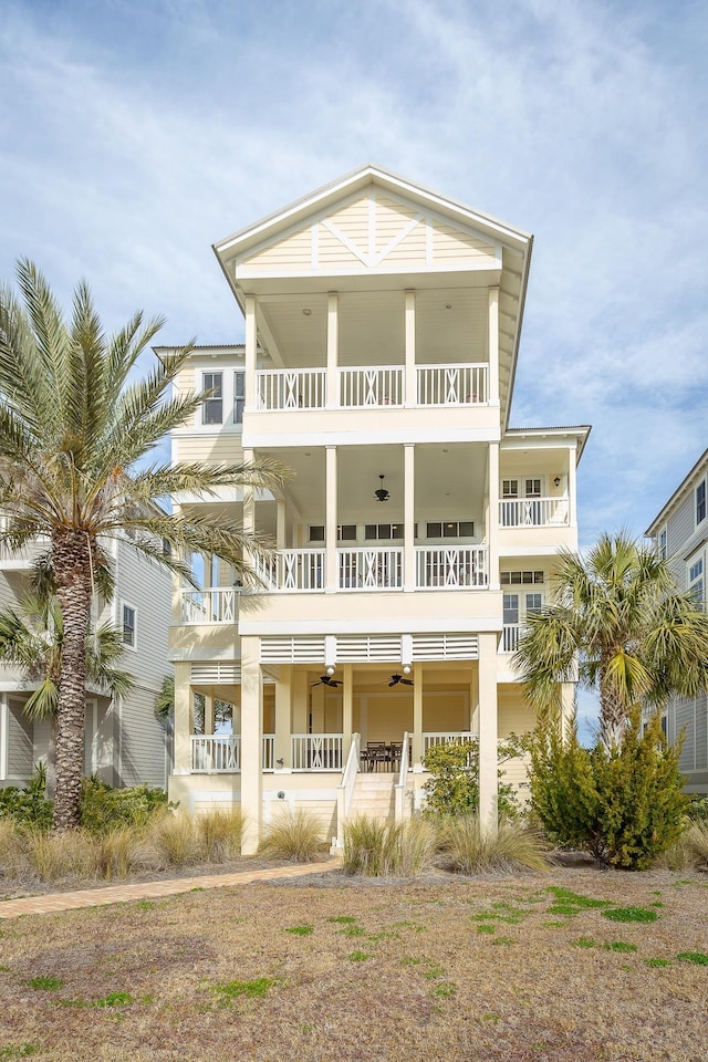 view of front of home featuring a balcony and ceiling fan