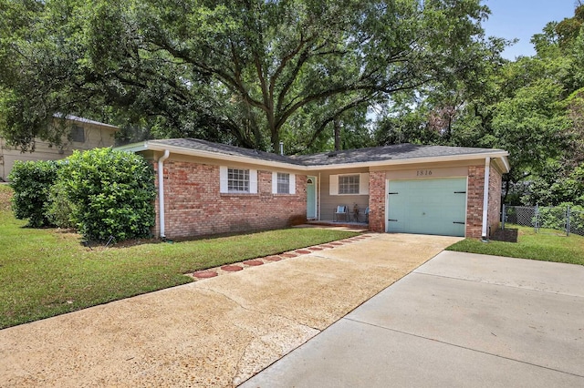 1816 Aaron Rd, Tallahassee, FL 32303 - view of front of house featuring a garage, brick siding, and concrete driveway