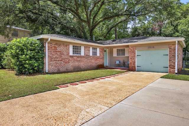 1816 Aaron Rd, Tallahassee, FL 32303 - ranch-style home featuring brick siding, concrete driveway, a garage, and a front yard