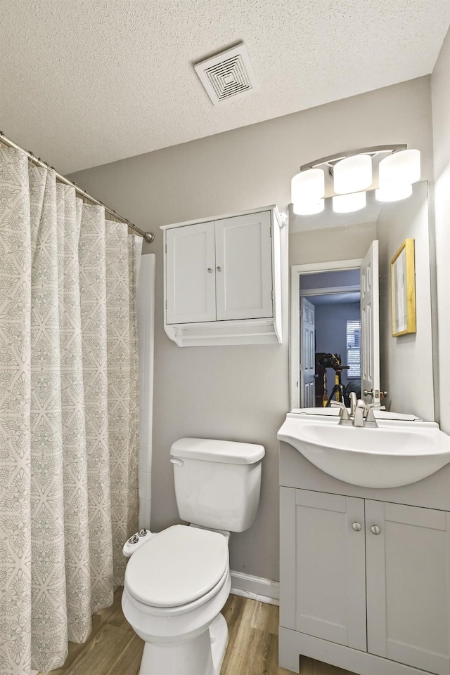 1816 Aaron Rd, Tallahassee, FL 32303 - full bathroom featuring wood finished floors, vanity, and a textured ceiling