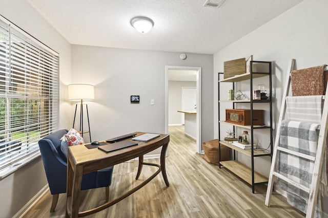 1816 Aaron Rd, Tallahassee, FL 32303 - office featuring light wood finished floors and a textured ceiling