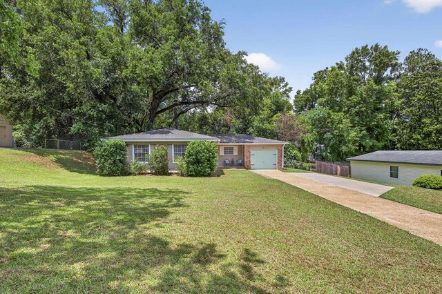 1816 Aaron Rd, Tallahassee, FL 32303 - view of front of house with driveway, a garage, and brick siding