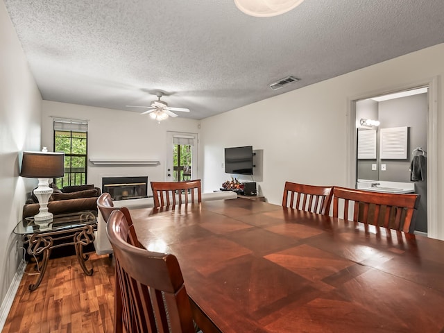 dining room featuring a textured ceiling, visible vents, a ceiling fan, and plenty of natural light