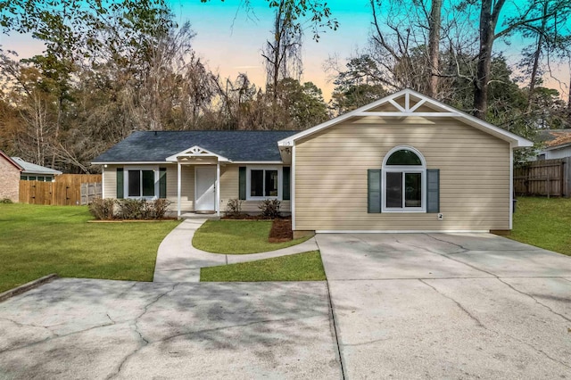 ranch-style home with a yard