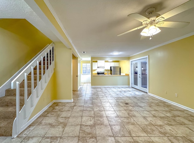 unfurnished living room with french doors, light tile patterned floors, ceiling fan, and ornamental molding