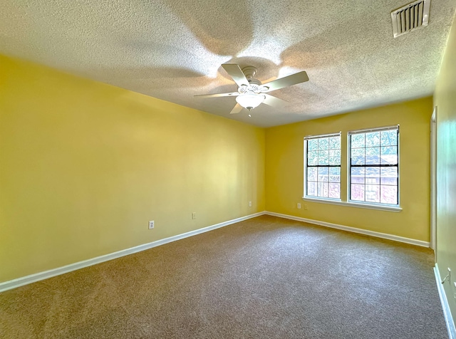 carpeted empty room featuring ceiling fan and a textured ceiling