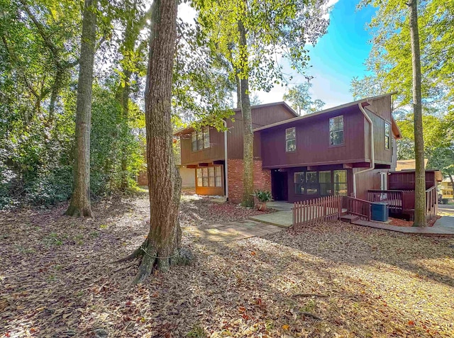 rear view of property with central AC