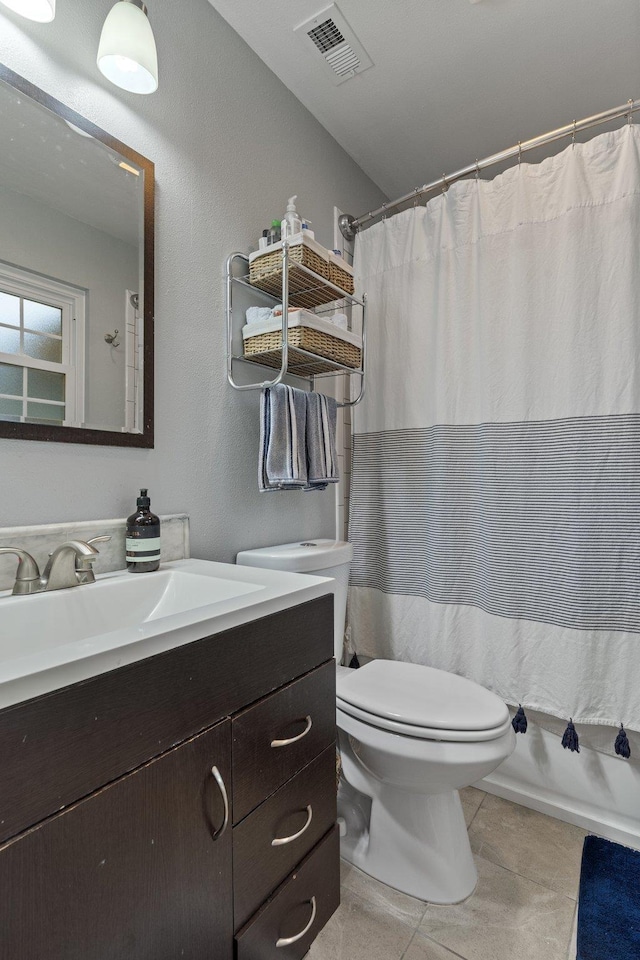 full bath featuring tile patterned flooring, vanity, visible vents, and toilet