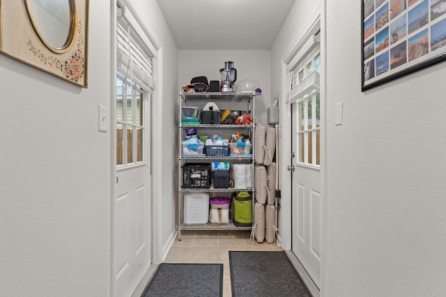 doorway to outside featuring plenty of natural light and tile patterned flooring
