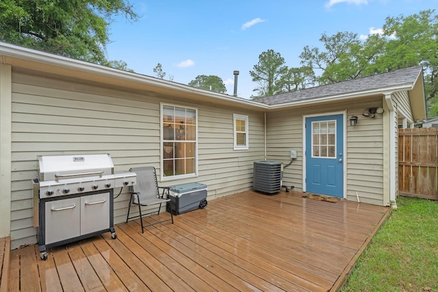 deck featuring central AC, a grill, and fence